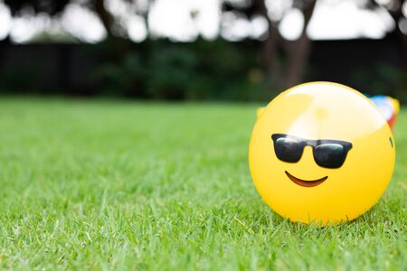 Children's plastic yellow ball with glassesの写真素材