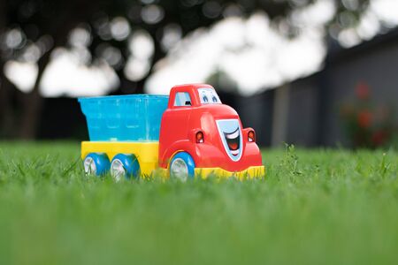 Plastic toy truck on grass