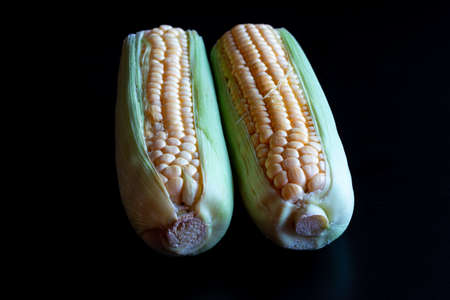 Fresh pealed mandarin / clementine on a black tableの写真素材