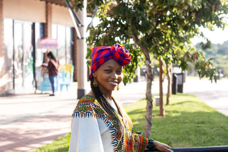 Fashionable black woman in ethnic clothes wearing traditional african style head scarf