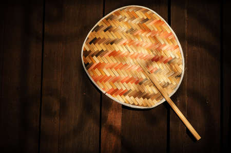 bamboo fan on wallの写真素材