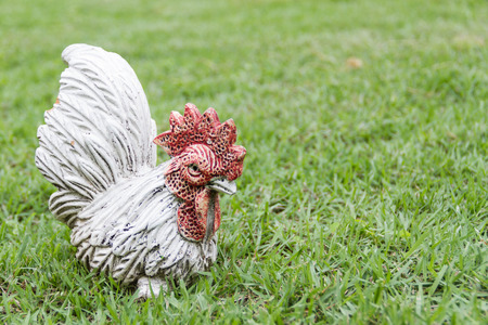 Sculpture cock stand on the gardenの写真素材