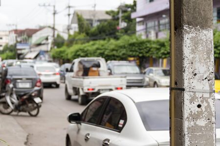 Electricity poles in tight trafficの写真素材