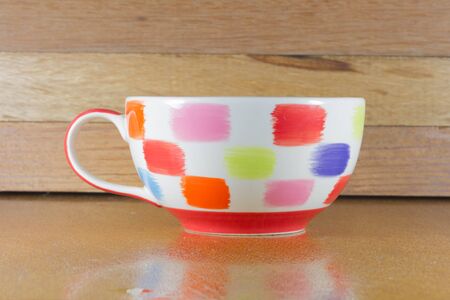 Coffee mug on the wooden backgroundの写真素材