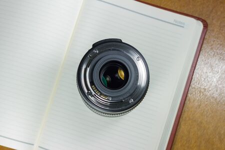 Camera photo lens on notebook ,concept photographyの写真素材