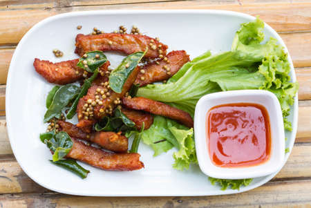 Deep fried pork with leech lime leaf and chili sauce