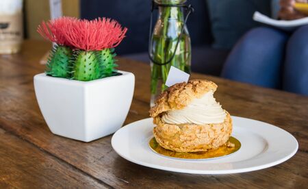 Eclair coffee cream in a dish on a wooden floor.の写真素材