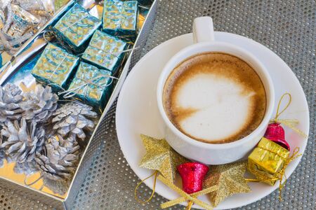 Close up blue cup of Coffee, latte on the steel table with Christmas decorationsの写真素材