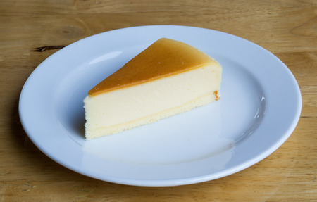 Cheesecake with dish on wooden backgroundの写真素材