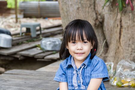 Portrait of adorable little girl with food debris stuck her mouthの写真素材