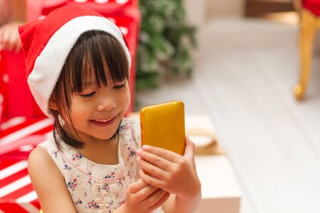 Cute girl child selfie with christmas treeの写真素材