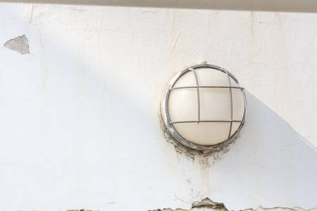 Old stone walls with old lantern for texture backgroundの写真素材