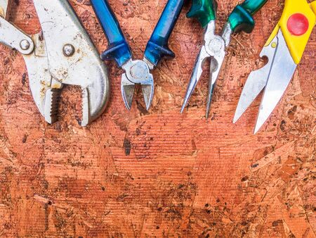 Set of hand tools on a wooden panel