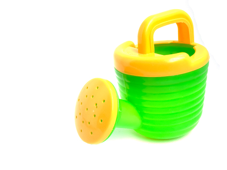 Green Yellow watering. Toys plastic watering on white background. Toys useful. Beach toys.の写真素材