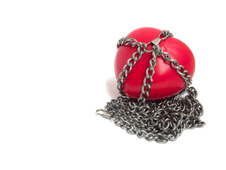 Red heart locked with chain. Love concept. Red heart locked on padlock. Love locked heart shape with chains on whiteの写真素材
