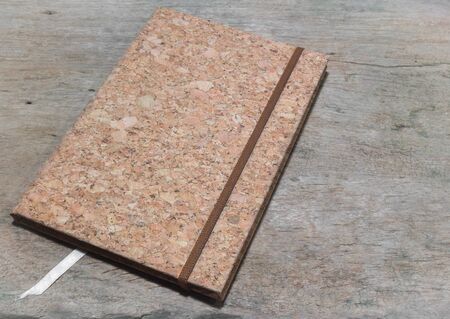 Notebook made from bark on the wooden table.の写真素材