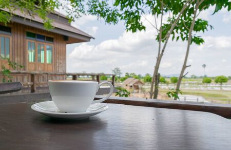 Close up white cup of Coffee, latte on the wooden tableの写真素材