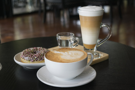 Selective focus white cup of Coffee, latte on the wooden table.の写真素材