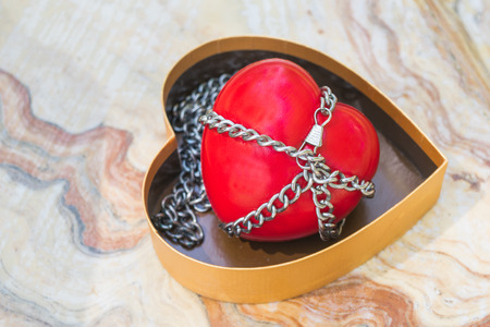 Red heart tied with chains, Valentine Concept.の写真素材