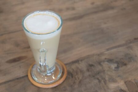 Cup of coffee on soft green sofa in the coffee shop. Coffee cup relaxation concept.の写真素材