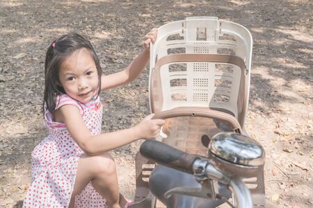 Asian cute girl riding bicycle in park.の写真素材