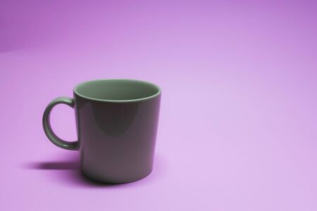 Brown coffee cup on purple background.の写真素材