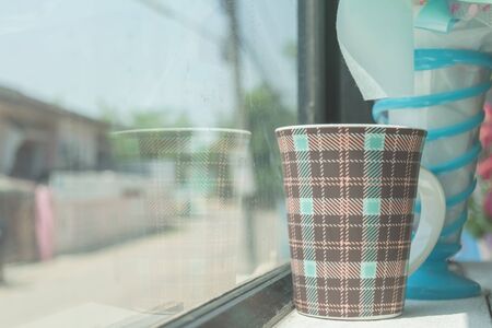 Mug of coffee on table in the coffee shop with flower.の写真素材