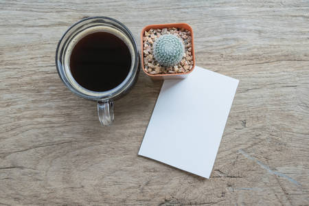 Cup of coffee with blank white paper for copy space in coffee shop.の写真素材