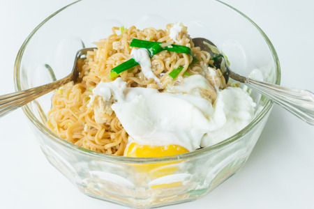 Close up spicy noodle with big egg. Concept food.の写真素材