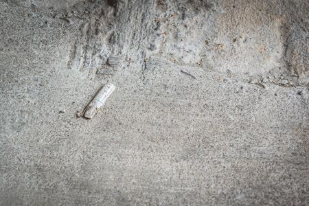The remains of cigarettes are left on the floor. Concept healthy care.