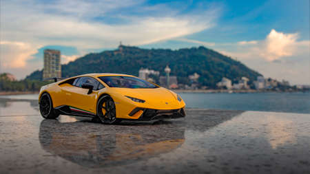 Yellow Lamborghini Huracan at beach parking lotのeditorial素材