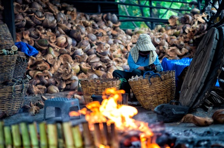 Workers are doing Lam sticky rice in bamboo tubeの写真素材