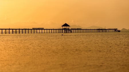 Wooden bridge at sunset  Reflections on water の写真素材