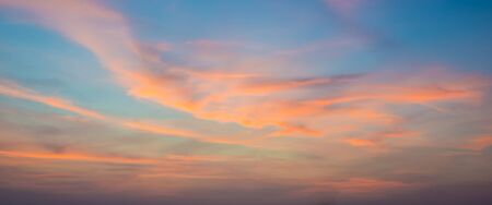 Sunset sky with orange colored clouds.の写真素材