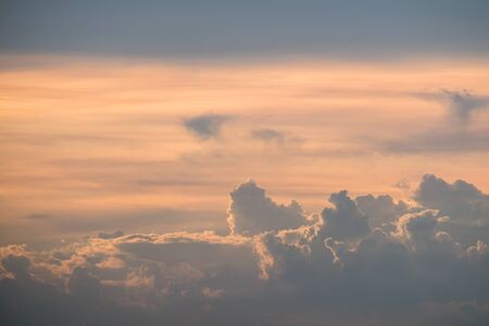 Sunset sky with orange colored clouds.