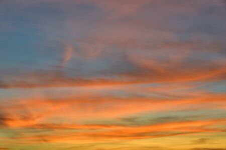 Sunset sky with orange colored clouds.