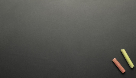Chalk is placed on a blackboard with space. Concept for education.の写真素材