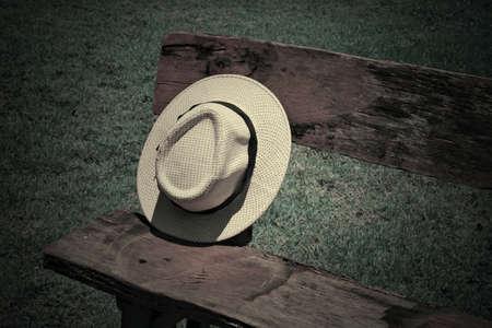 White hat woven on old woodの写真素材