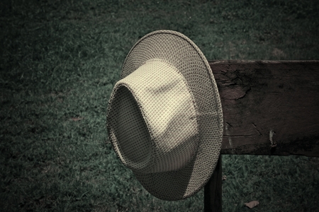White hat woven on old woodの写真素材