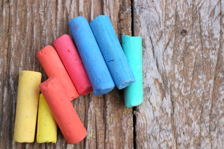 Colored Chalk on old wood backgroundの写真素材
