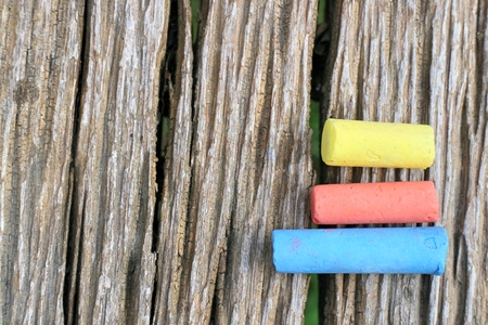 Colored Chalk on old wood backgroundの写真素材