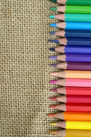 colored pencils on sackcloth backgroundの写真素材
