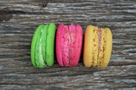 Colorful French Macaroon on wooden backgroundの写真素材