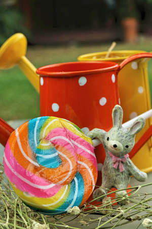 Colorful candies in vase on table on wooden background