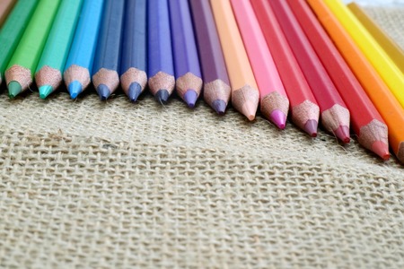 colored pencils on sackcloth backgroundの写真素材