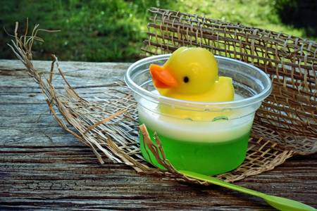 yellow duck jelly on wooden plates , delicious dessertの写真素材