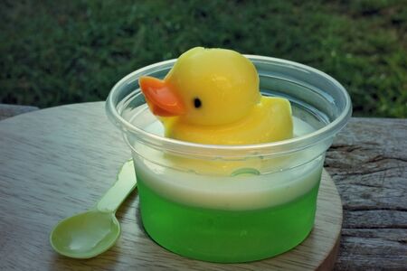 yellow duck jelly on wooden plates , delicious dessertの写真素材