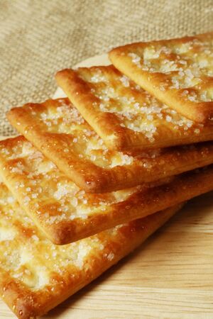 Biscuits sprinkled sugar on wooden platesの写真素材
