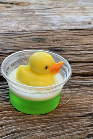 yellow duck jelly on wooden plates , delicious dessertの写真素材