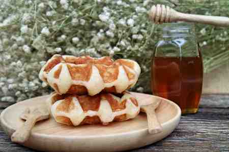 waffle and chocolate sauce on wooden platesの写真素材